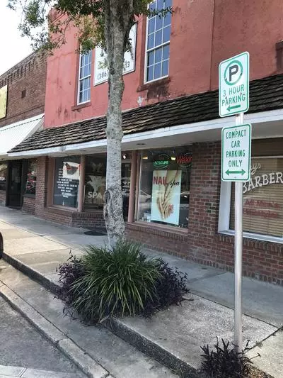 compact car parking only sign posted on Main Street