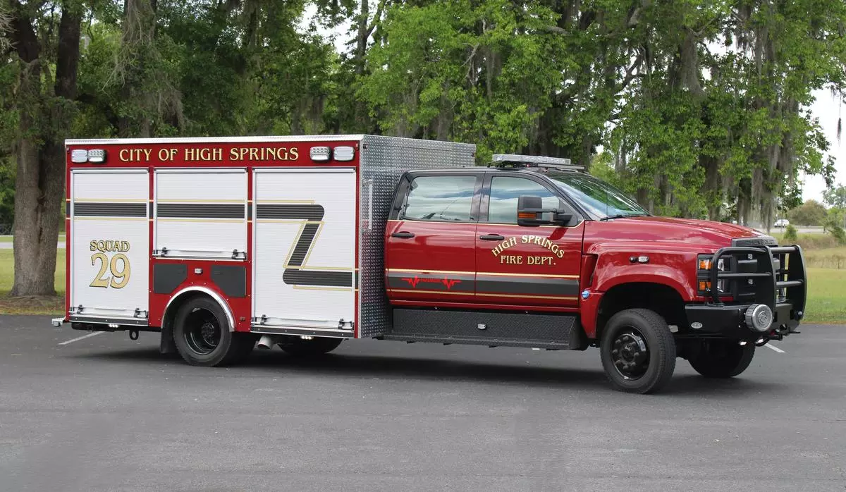 image shows a fire truck with black over red paint and a silver utility body
