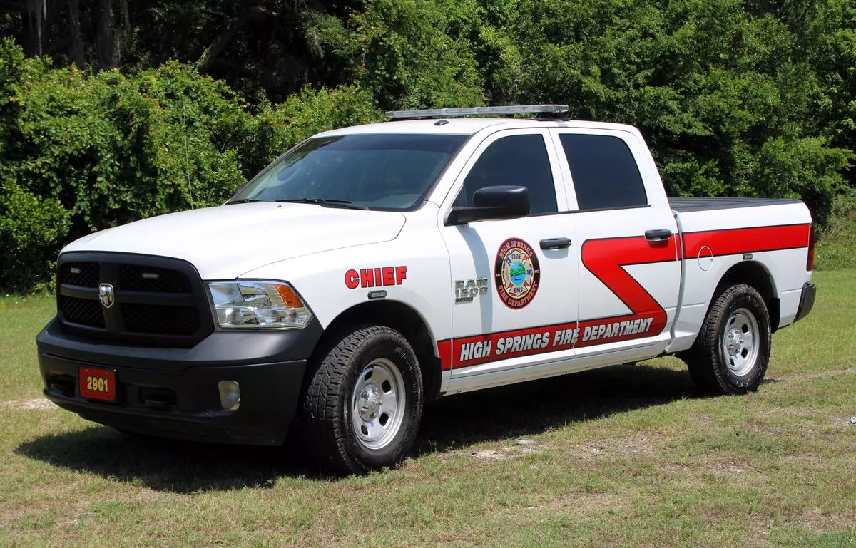 white pickup truck with red stripes and lettering that says high springs fire department
