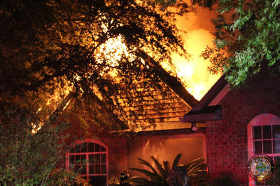 image of Fire coming from the roof of a home 