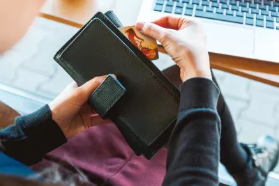 Image of woman using credit card to pay online