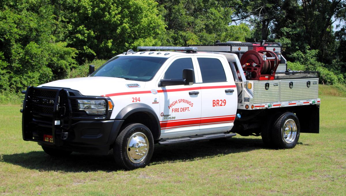 white truck with red lettering that says high springs fire department brush 29